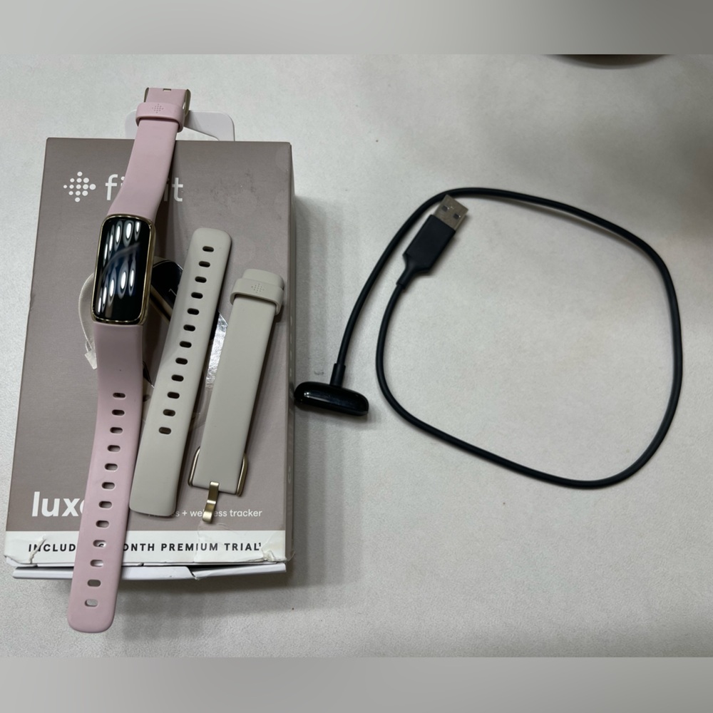 Fitbit Luxe with charging cable and two bands